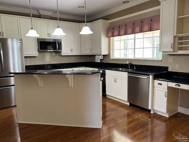 kitchen with a sink, open shelves, dark countertops, appliances with stainless steel finishes, and crown molding