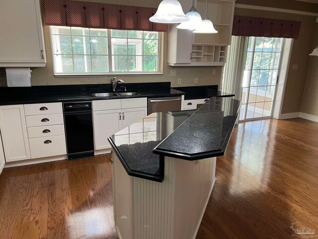 kitchen featuring dark wood-type flooring, a sink, stainless steel dishwasher, a kitchen island, and white cabinets