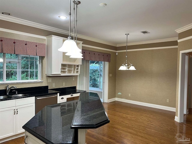 kitchen with a sink, white cabinets, visible vents, and stainless steel dishwasher