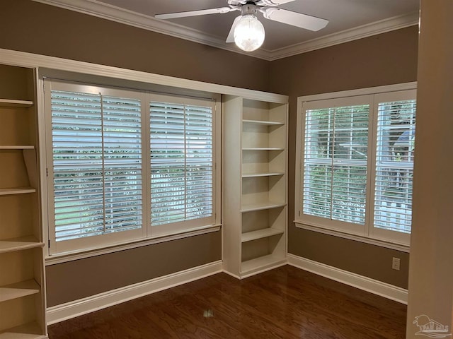 empty room with dark wood-style flooring, baseboards, a ceiling fan, and ornamental molding