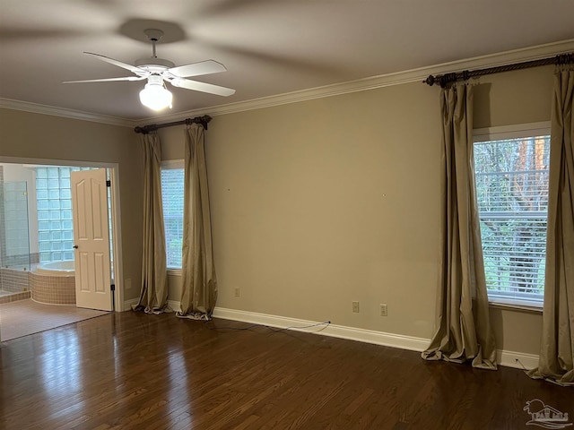 unfurnished room featuring dark wood-type flooring, a ceiling fan, baseboards, and ornamental molding