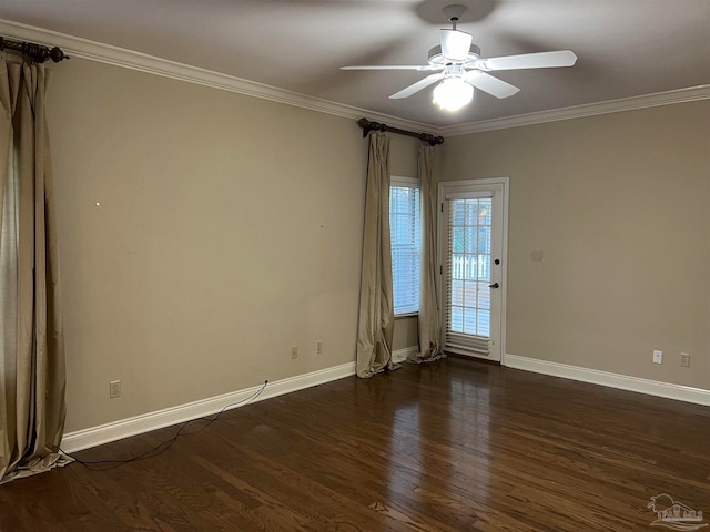 empty room with baseboards, dark wood finished floors, a ceiling fan, and ornamental molding