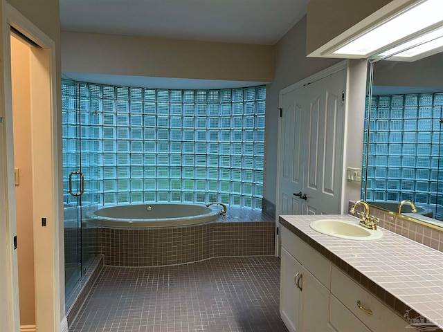 full bath with vanity, tile patterned floors, a garden tub, and a stall shower