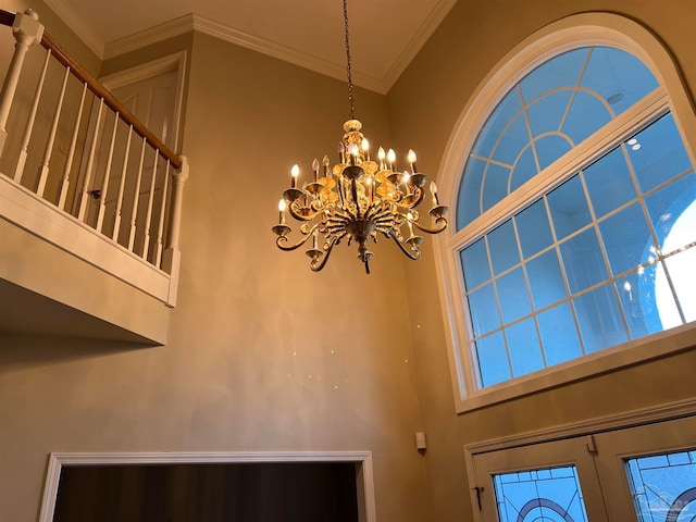 details with ornamental molding and a notable chandelier