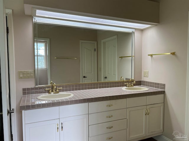 bathroom with double vanity and a sink