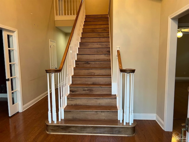 stairway with baseboards and wood finished floors