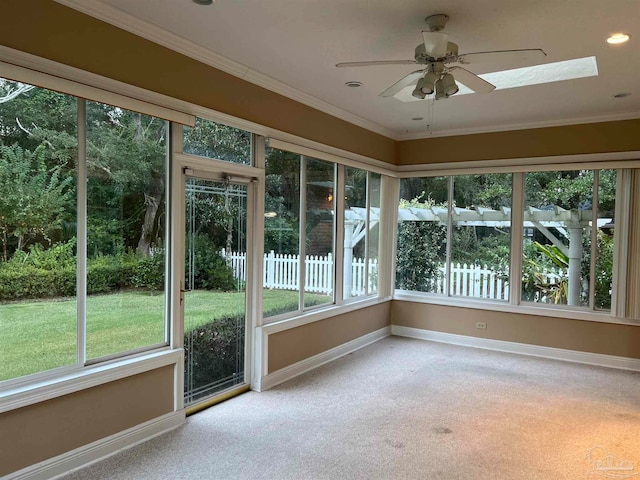 unfurnished sunroom featuring a skylight and a ceiling fan