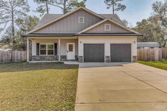 craftsman-style house featuring a garage, covered porch, and a front lawn