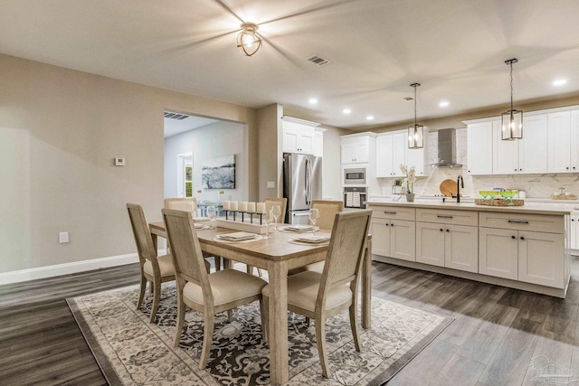 dining room with dark hardwood / wood-style flooring and sink