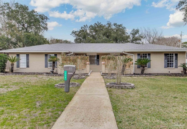 single story home with a front lawn and brick siding