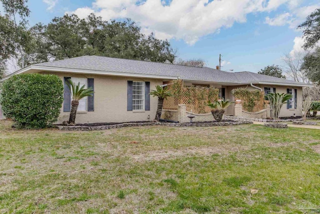 ranch-style home with a front lawn and brick siding