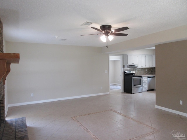 unfurnished living room with visible vents, a ceiling fan, light tile patterned floors, baseboards, and a fireplace