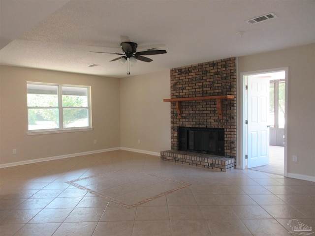 unfurnished living room featuring visible vents, baseboards, tile patterned flooring, and ceiling fan
