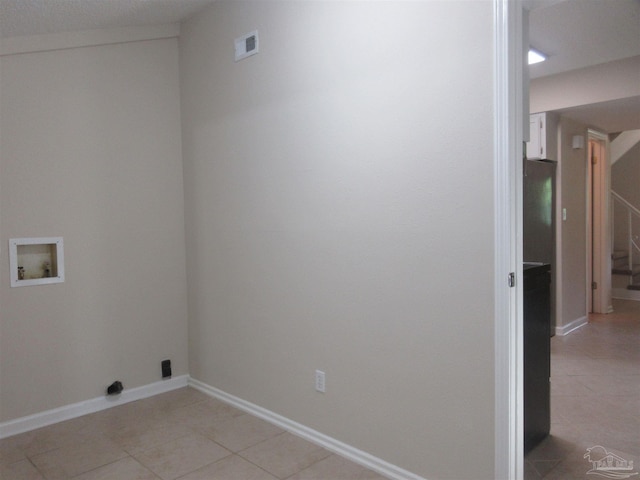 laundry room featuring light tile patterned floors, visible vents, baseboards, laundry area, and washer hookup