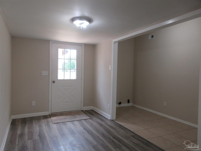 entryway featuring wood finished floors, visible vents, and baseboards