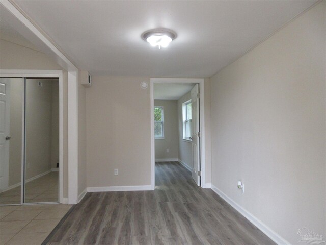 interior space featuring baseboards, wood finished floors, and a closet