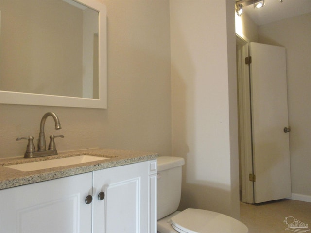 bathroom with toilet and vanity