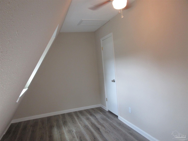spare room with baseboards, a ceiling fan, and wood finished floors