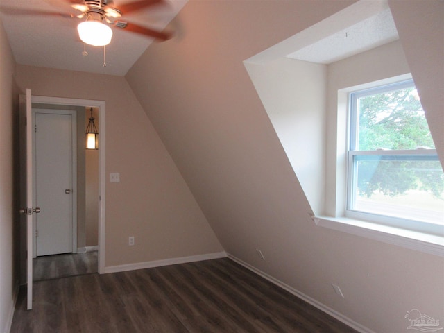 bonus room featuring wood finished floors, a ceiling fan, and baseboards