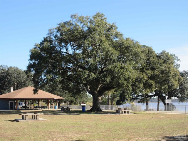 view of home's community featuring a lawn, a gazebo, and fence