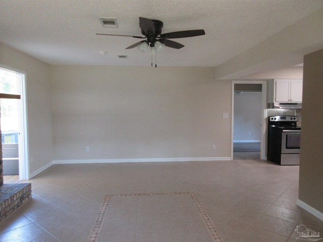 unfurnished living room featuring baseboards, a ceiling fan, light tile patterned flooring, and visible vents