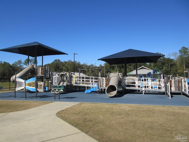 view of parking / parking lot featuring playground community