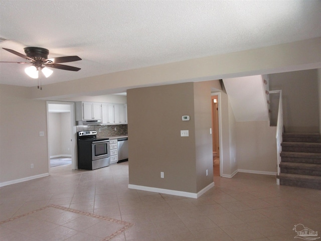 kitchen featuring backsplash, appliances with stainless steel finishes, ceiling fan, and light tile patterned floors