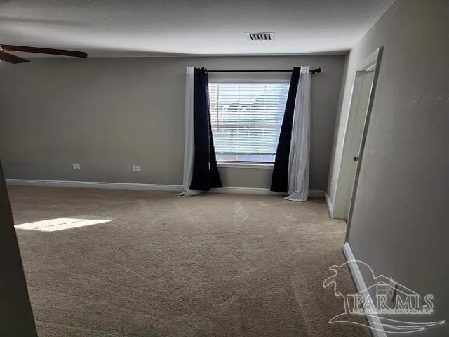 unfurnished room featuring carpet flooring and ceiling fan