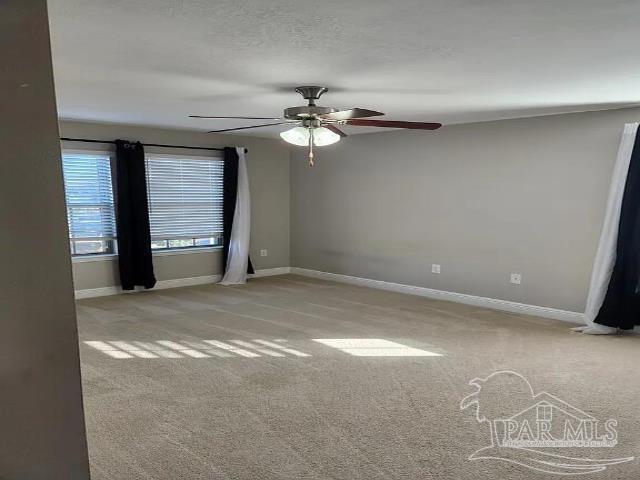 unfurnished room featuring ceiling fan and light carpet