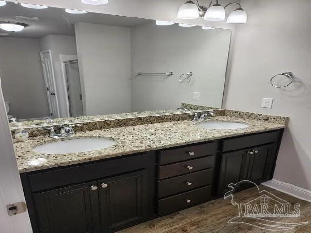 bathroom with vanity and hardwood / wood-style flooring