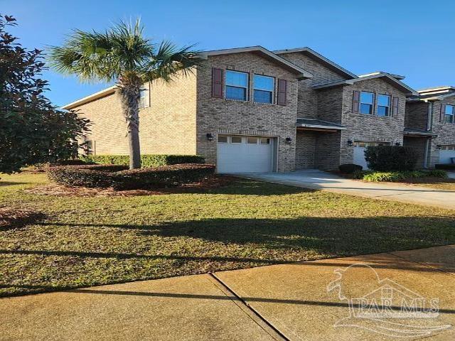 view of front of house with a garage and a front yard