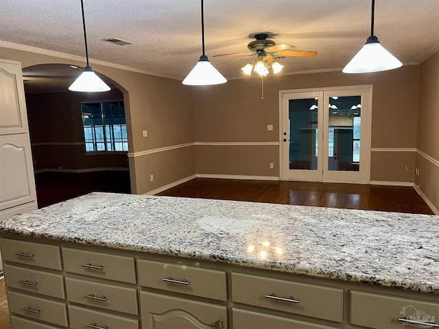 kitchen with ceiling fan, pendant lighting, a textured ceiling, and dark wood-type flooring