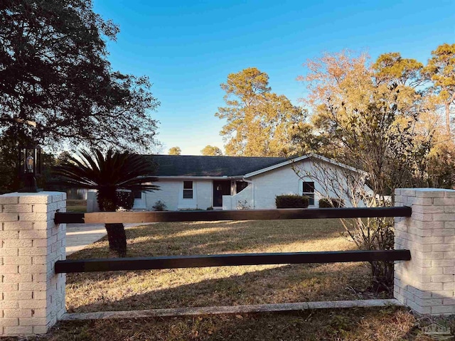 ranch-style home featuring a front yard