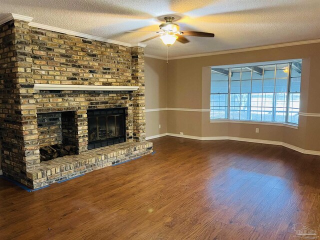 unfurnished living room with hardwood / wood-style floors, ceiling fan, ornamental molding, a fireplace, and a textured ceiling