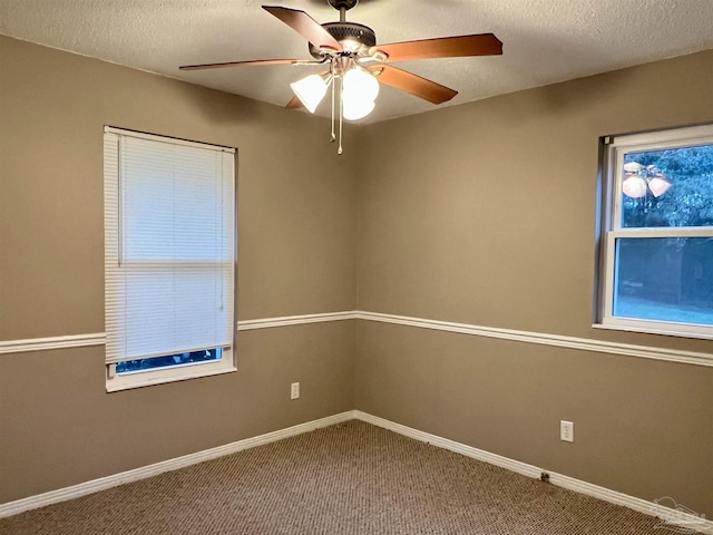 unfurnished room with carpet floors, ceiling fan, and a textured ceiling