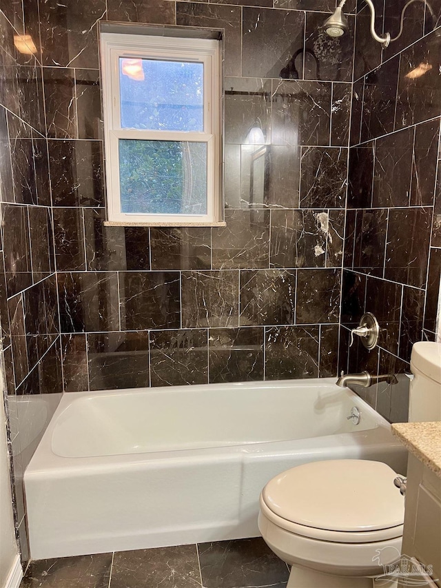 full bathroom with toilet, vanity, tile walls, and  shower combination