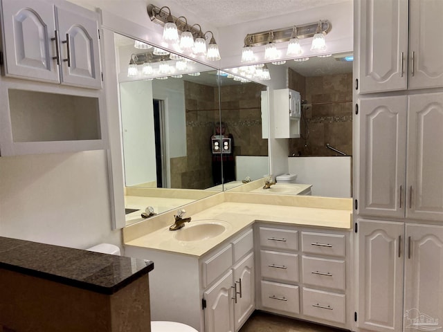 bathroom featuring a textured ceiling and vanity