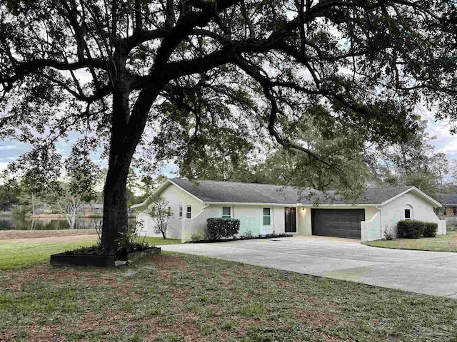 ranch-style house featuring a front yard and a garage