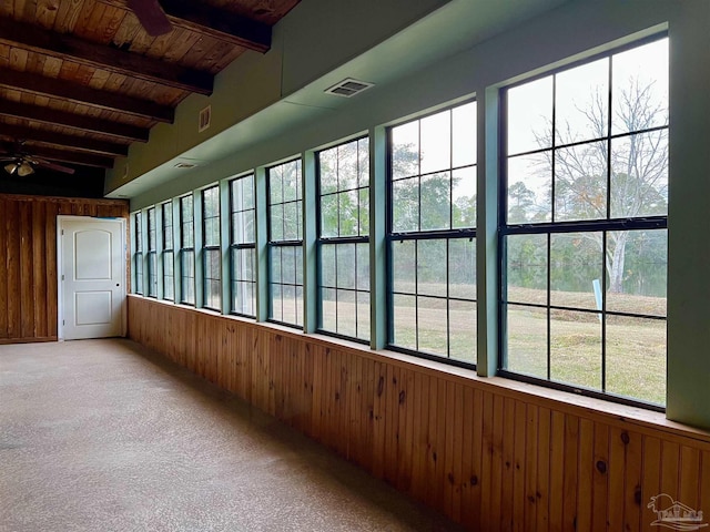 interior space featuring beam ceiling, ceiling fan, a healthy amount of sunlight, and wooden ceiling