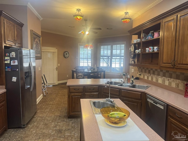 kitchen featuring sink, tasteful backsplash, ornamental molding, appliances with stainless steel finishes, and ceiling fan