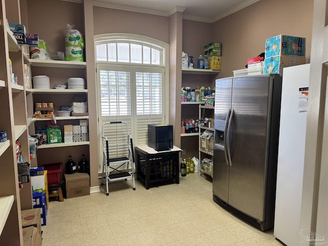 kitchen with white refrigerator, ornamental molding, and stainless steel fridge with ice dispenser