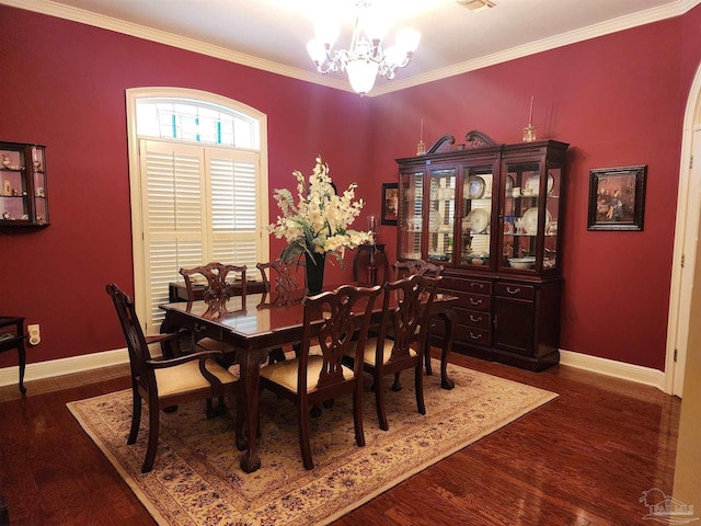 dining area featuring crown molding, dark hardwood / wood-style floors, and an inviting chandelier