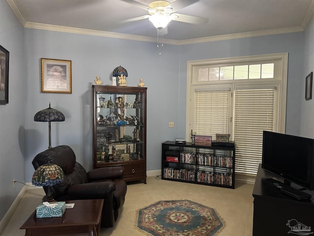 sitting room with ornamental molding, ceiling fan, and carpet