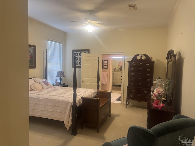 bedroom with ceiling fan, light colored carpet, ornamental molding, and connected bathroom