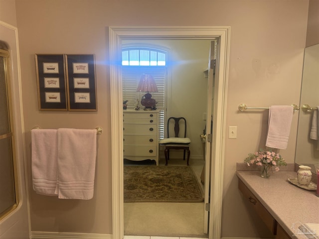 bathroom featuring an enclosed shower and vanity