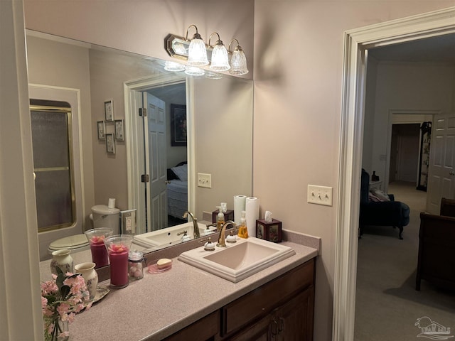 bathroom featuring enclosed tub / shower combo and vanity