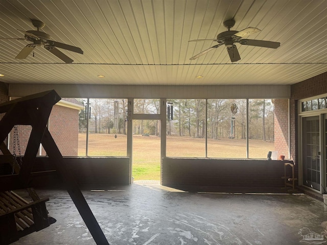 unfurnished sunroom featuring wooden ceiling and ceiling fan