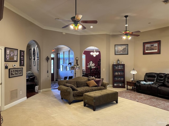 carpeted living room with ceiling fan with notable chandelier and ornamental molding