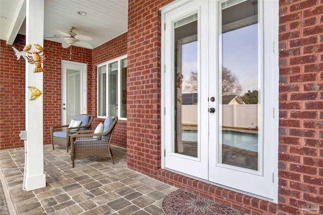 view of exterior entry with french doors, a patio, and ceiling fan