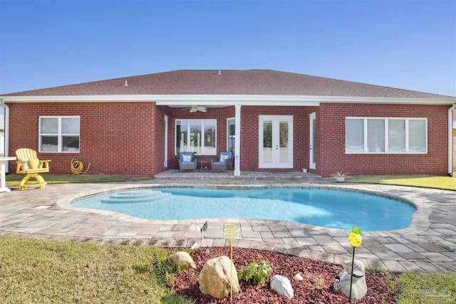 view of swimming pool featuring ceiling fan, a patio, and french doors